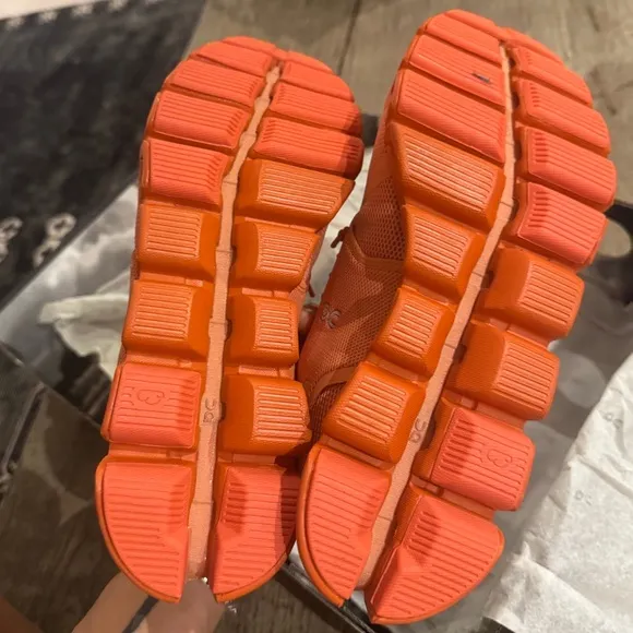On Cloud Monocrome Shoes in Orange.