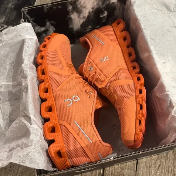 On Cloud Monocrome Shoes in Orange.